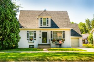 A resident checks a rental home’s exterior while inspecting gutters, windows, and outdoor fixtures.